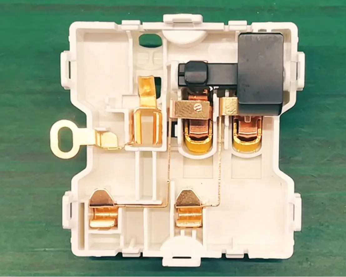 Internal structure of modular electrical wall switch and socket components.png