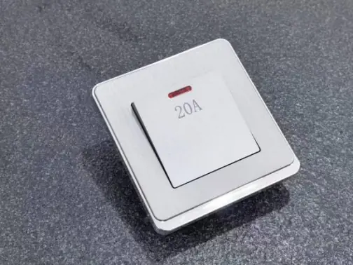 A 20A switch with Silver frame for LIBAIK V12 light switch on a dark, showcasing its premium feel.png