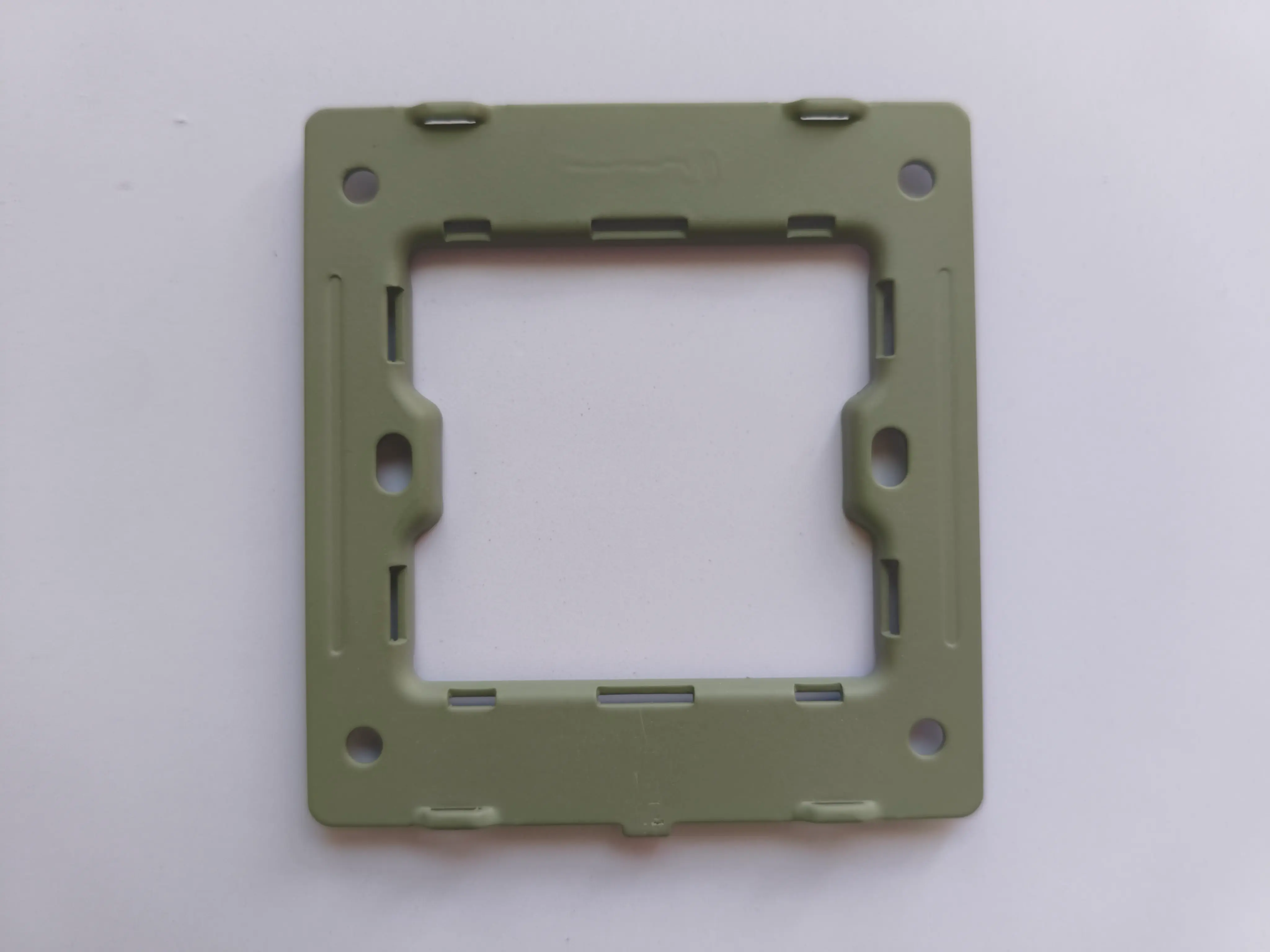 Steel mounting frame for a BS standard wall switch or socket